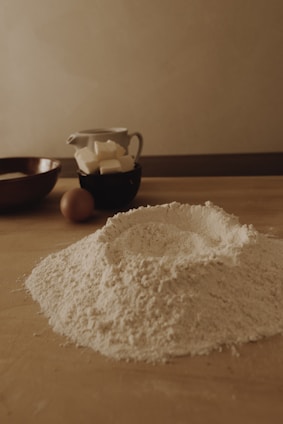 A cozy kitchen with fresh ingredients and baking tools arranged on a wooden table.