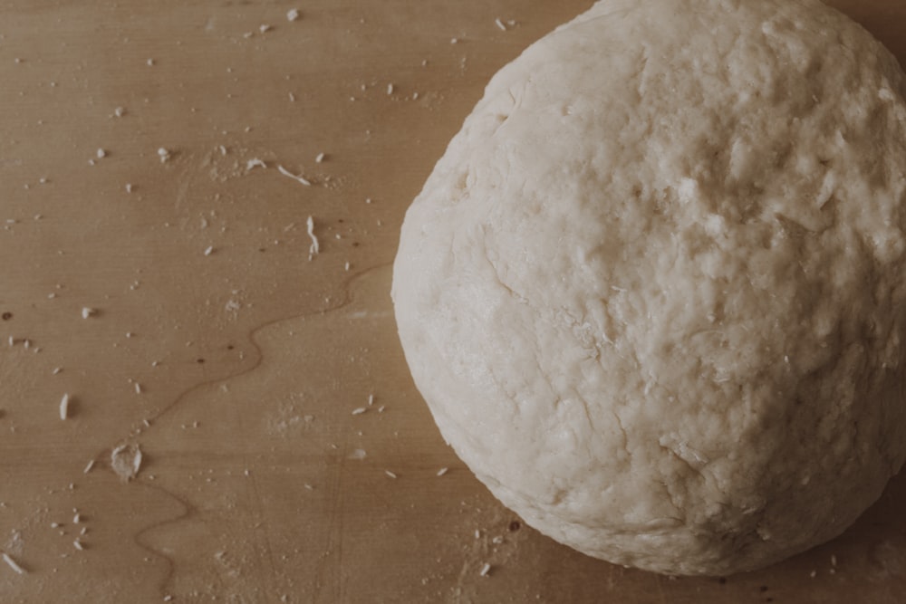 white dough on brown wooden table