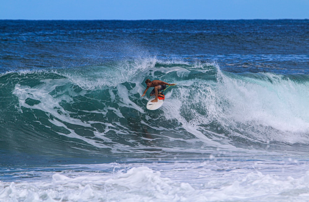 person surfing on sea waves during daytime