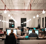 people sitting on chair in front of computer