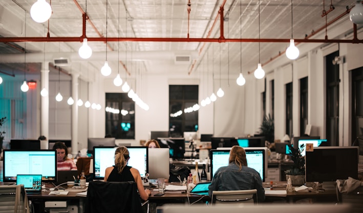 people sitting on chair in front of computer