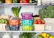 A man smiling while organizing fresh fruits and vegetables in a spotless fridge.