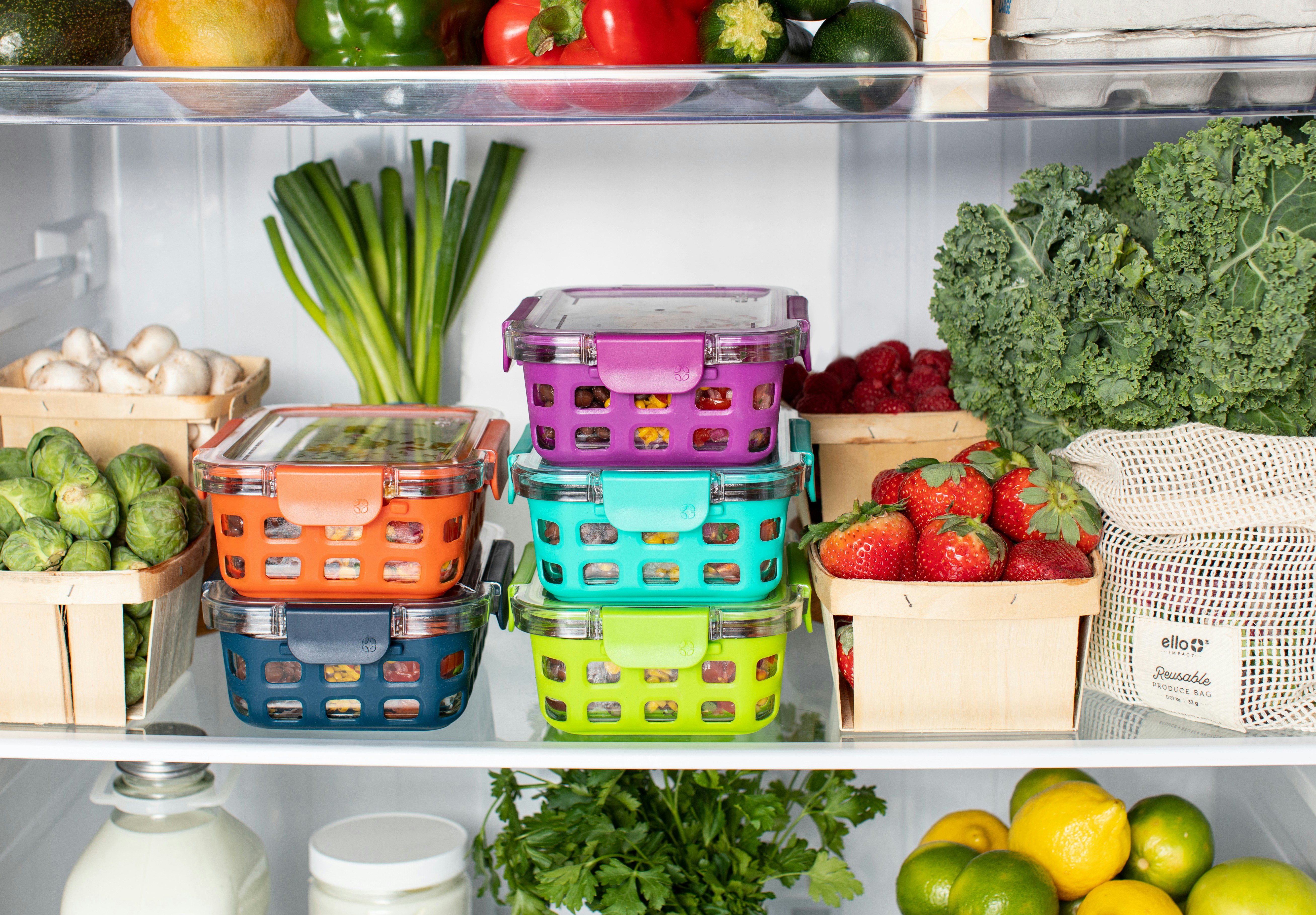 [ID: a photo of an open fridge, inside is various fruits and vegetables.]