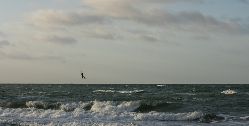 person surfing on sea waves during daytime