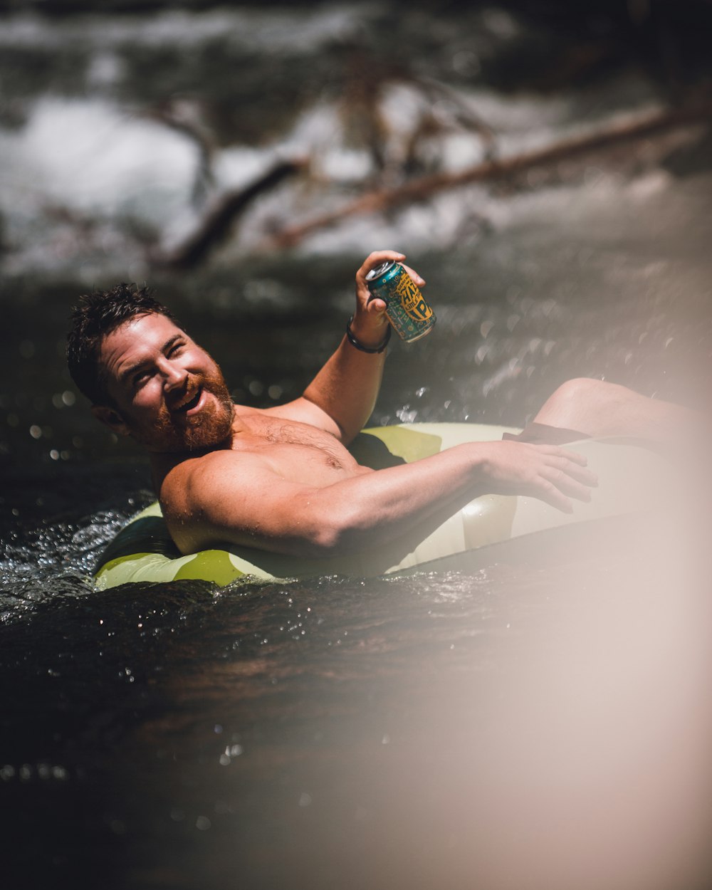 man in green and black shorts in water