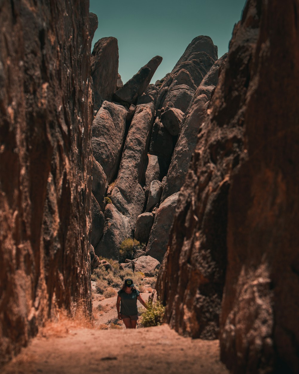 person in black jacket standing near rock formation during daytime