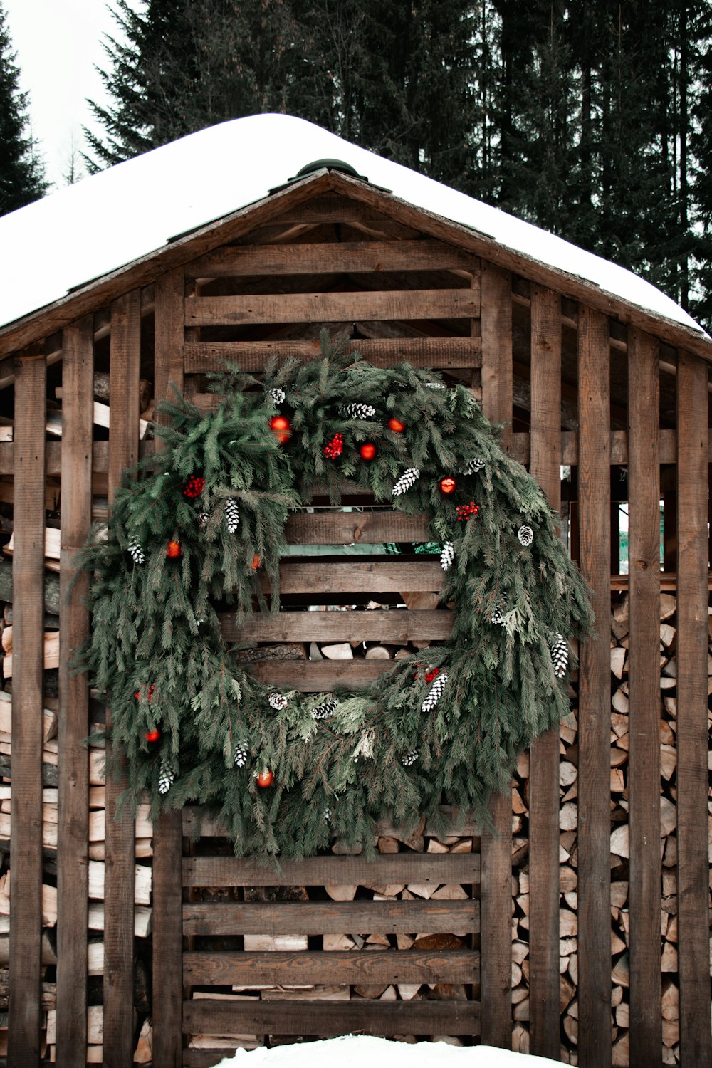 green wreath on brown wooden fence