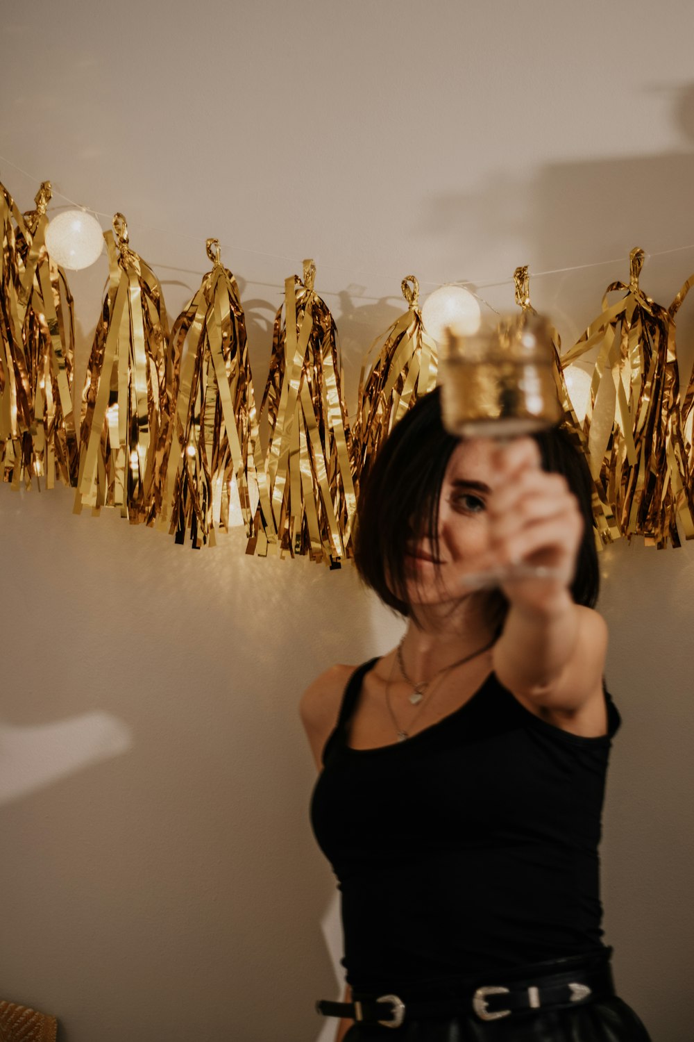 woman in black tank top wearing gold crown