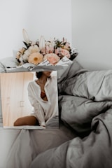 Close-up of fresh flowers on the bedside table adding a homely touch.
