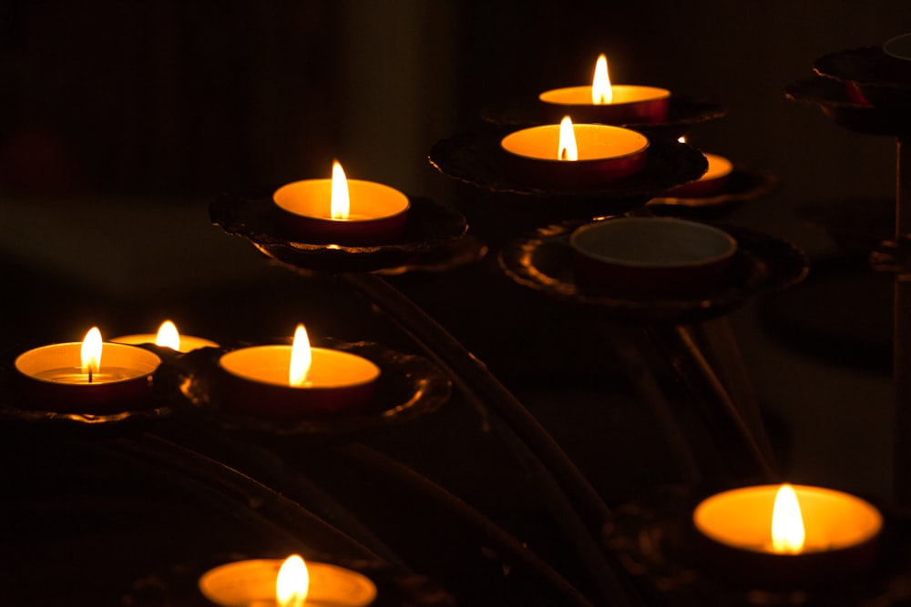 lighted candles on black metal candle holder