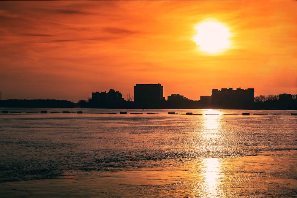 silhouette of city buildings during sunset