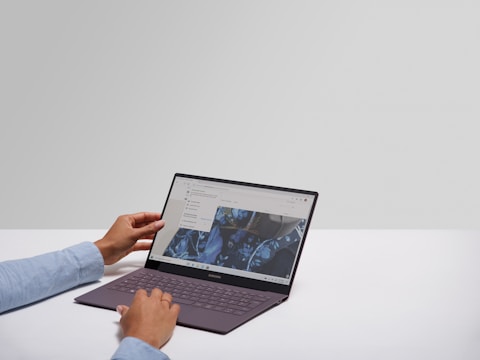 Person using laptop with integration icons floating around screen.