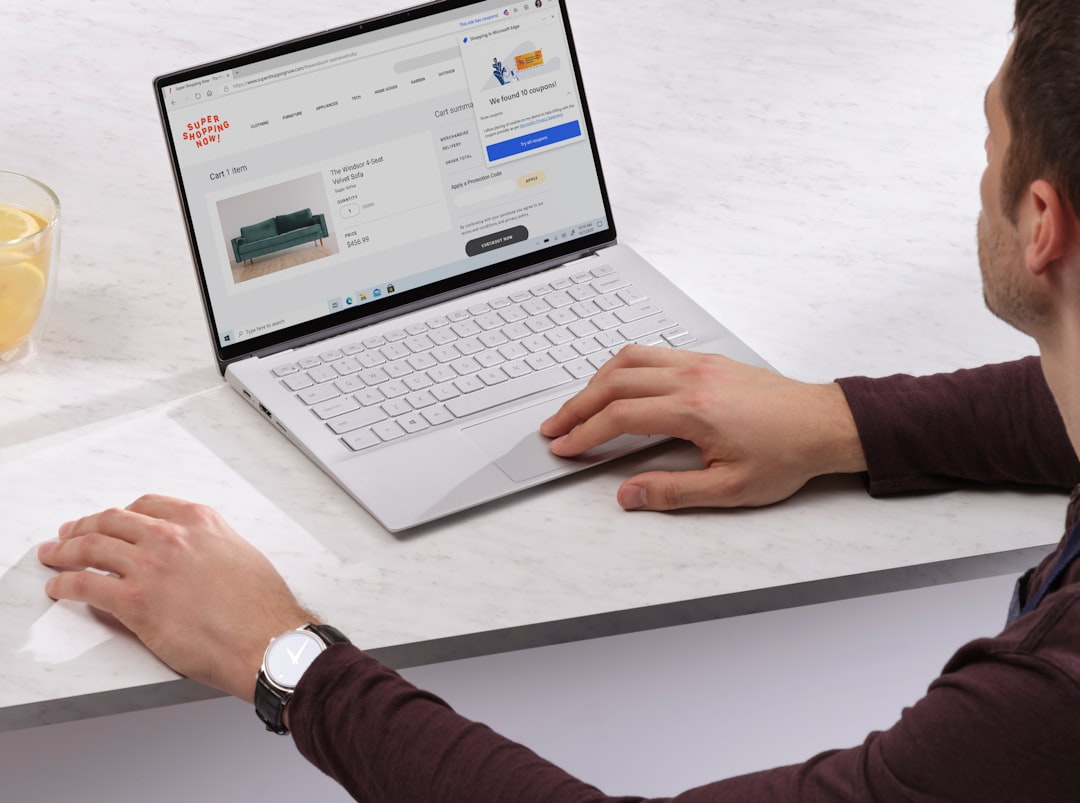 person using Surface laptop on table