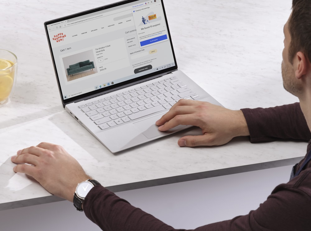 person using Surface laptop on table