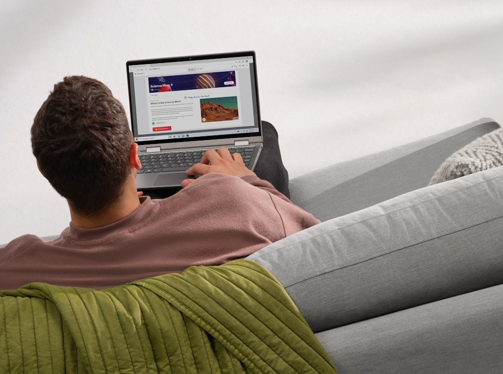 man in red sweater using laptop computer