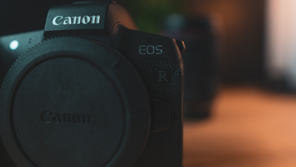 black nikon dslr camera on brown wooden table