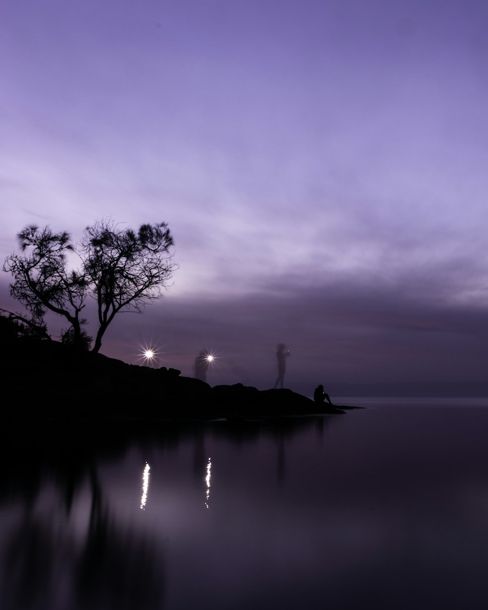 silhouette of person on boat on water during sunset