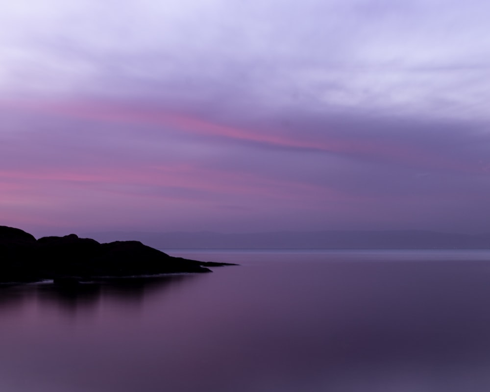 body of water under cloudy sky during daytime