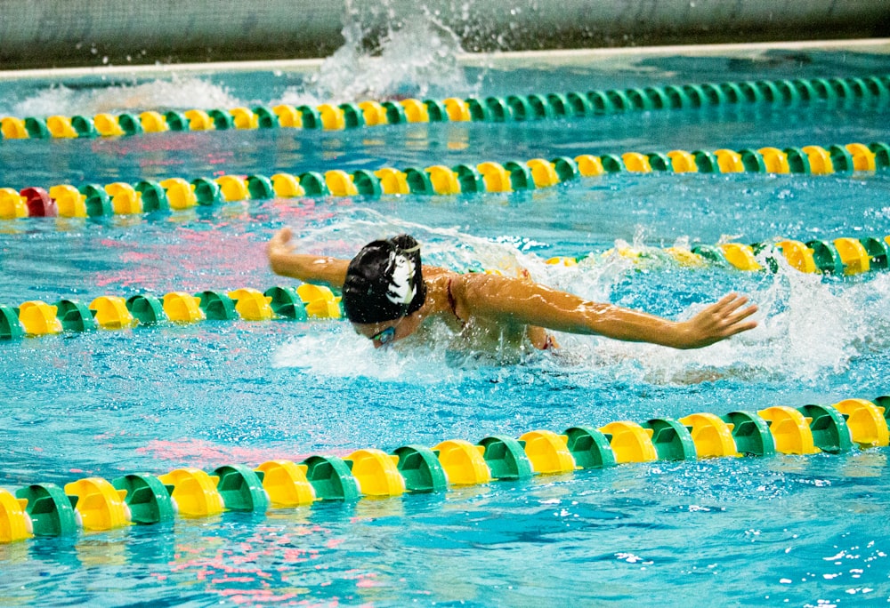 person in swimming pool during daytime