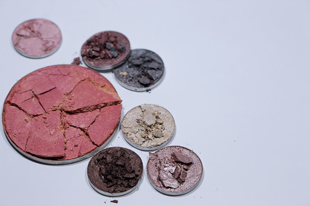 eight round silver coins on white surface