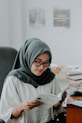 woman in white hijab and black framed eyeglasses