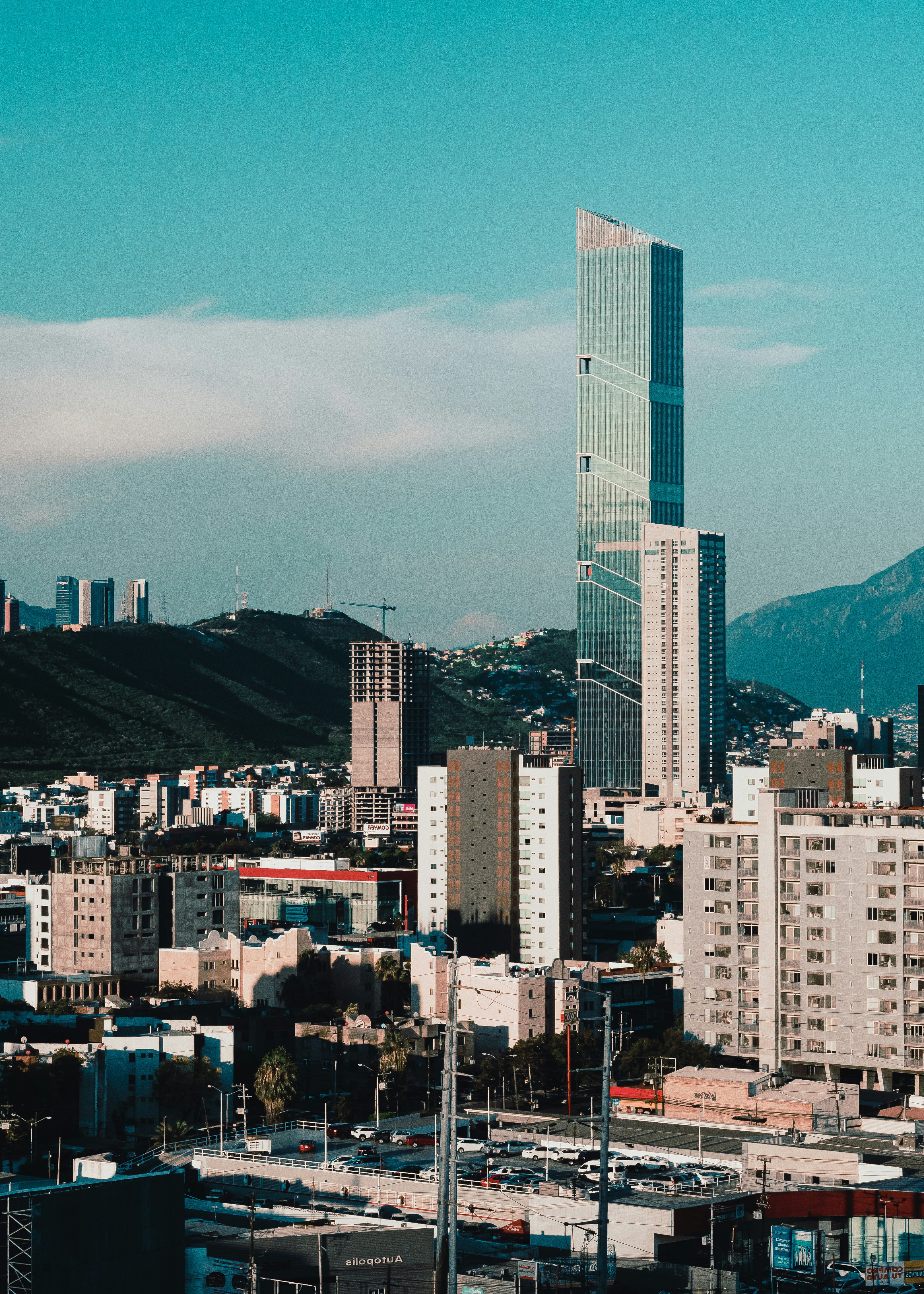 high rise buildings near mountain during daytime