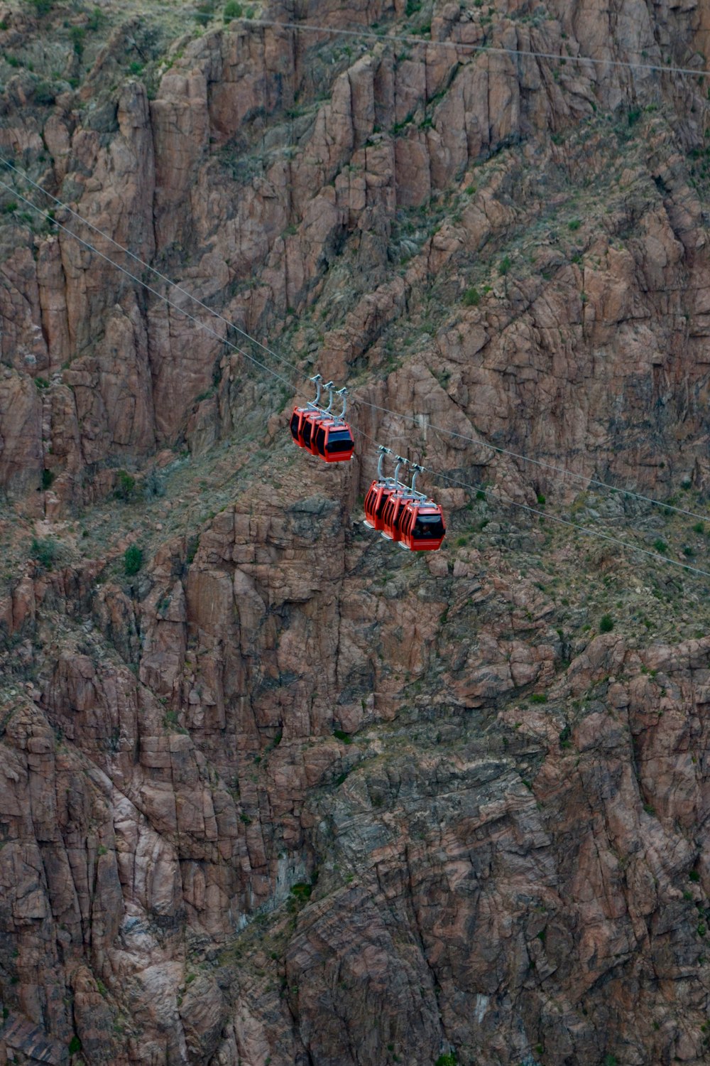 red and white cable car on mountain