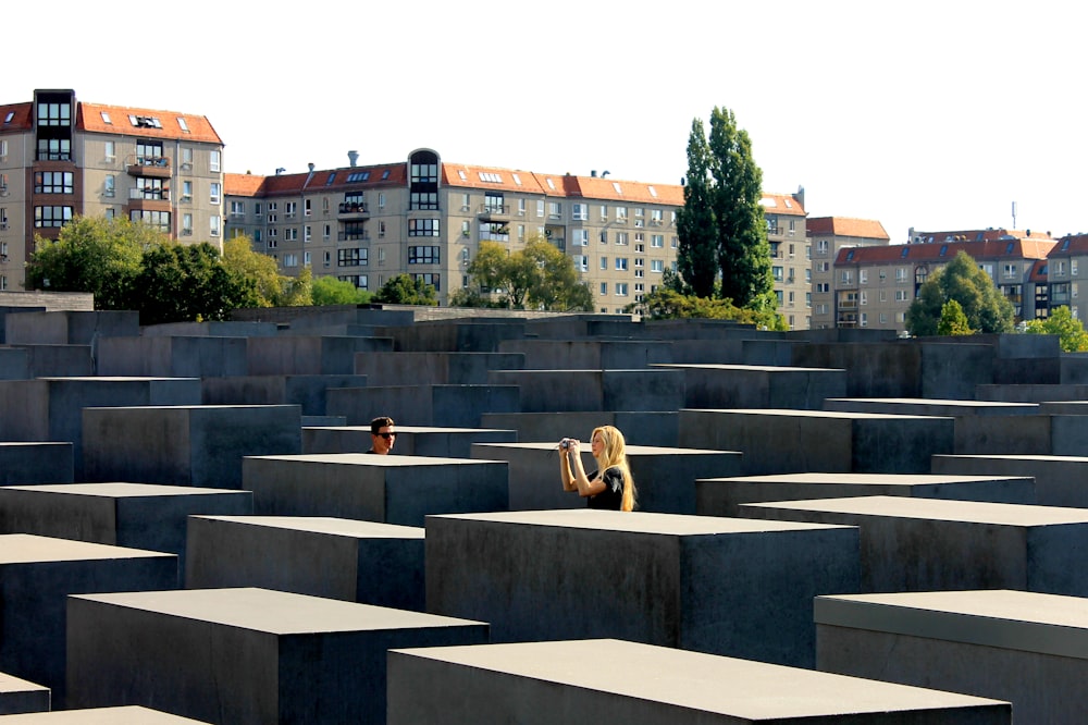 people sitting on gray concrete bench during daytime