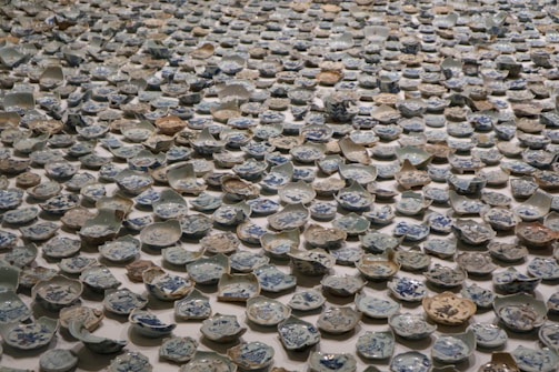 An artistic arrangement of various ceramic cups and plates.