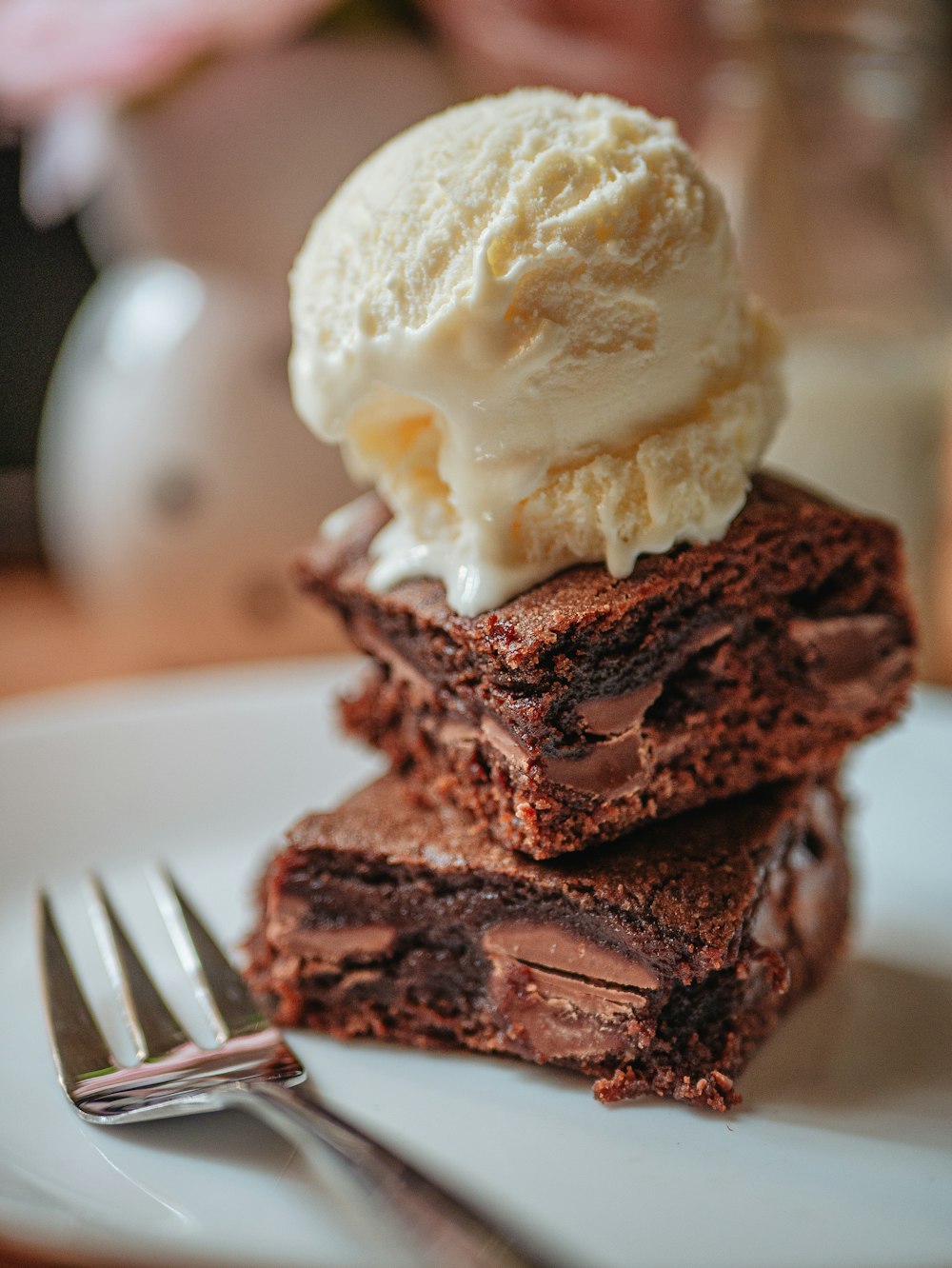 chocolate cake with white ice cream on white ceramic plate