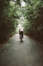 person in white jacket riding on black motorcycle on gray concrete road during daytime
