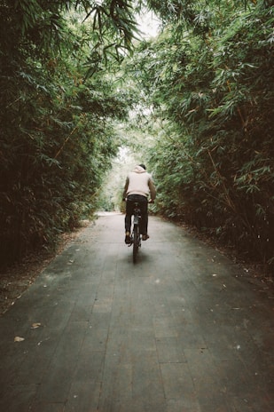 person in white jacket riding on black motorcycle on gray concrete road during daytime