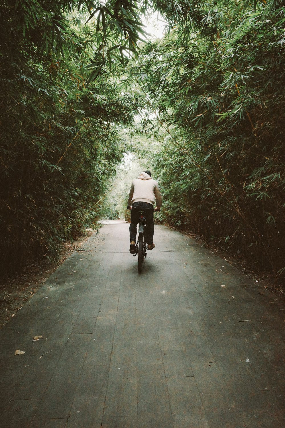 person in white jacket riding on black motorcycle on gray concrete road during daytime