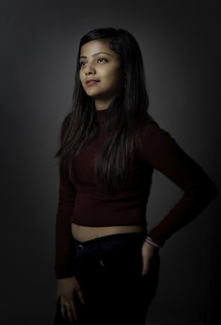 A serene model wearing comfortable dark-themed clothing.
