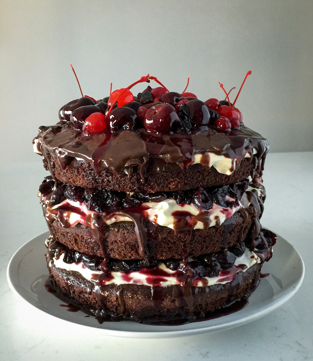 chocolate cake with strawberry on white ceramic plate