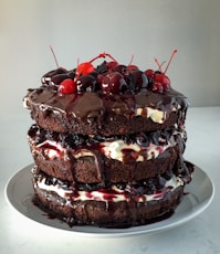 chocolate cake with strawberry on white ceramic plate