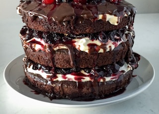 chocolate cake with strawberry on white ceramic plate