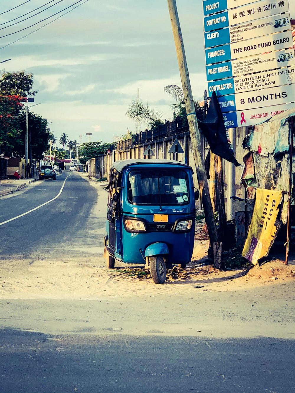 blue and yellow auto rickshaw on road during daytime