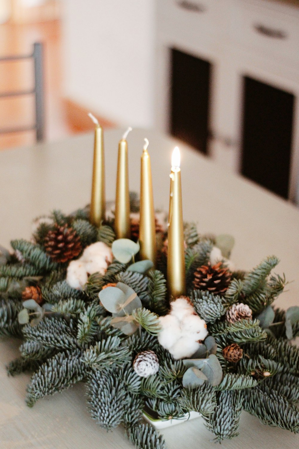 three lighted candles on white table