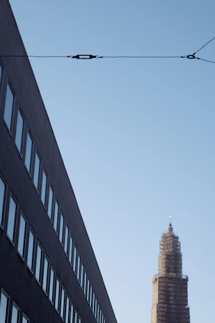 Wide shot of a modern commercial building under construction with visible utility connection points.