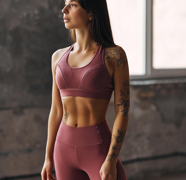 woman in pink sports bra and pink leggings