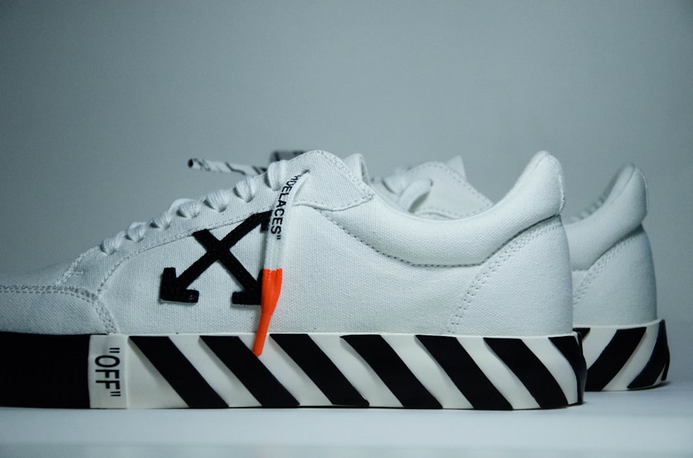 white and black adidas athletic shoe