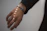 A close-up of a sleek smart ring glowing softly on a wrist in natural light.