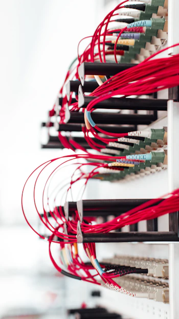 Technician carefully installing network cables in a modern data center rack.