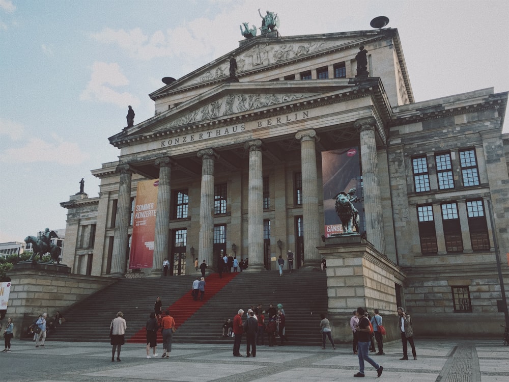 people walking in front of building during daytime