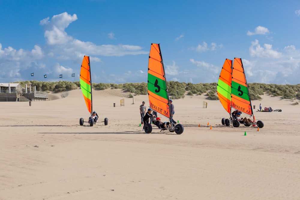 people riding on red orange and yellow parachute during daytime