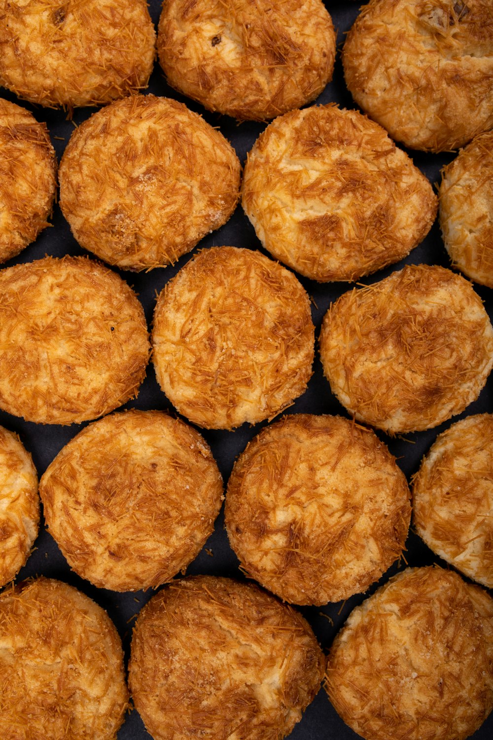 brown cookies on black surface