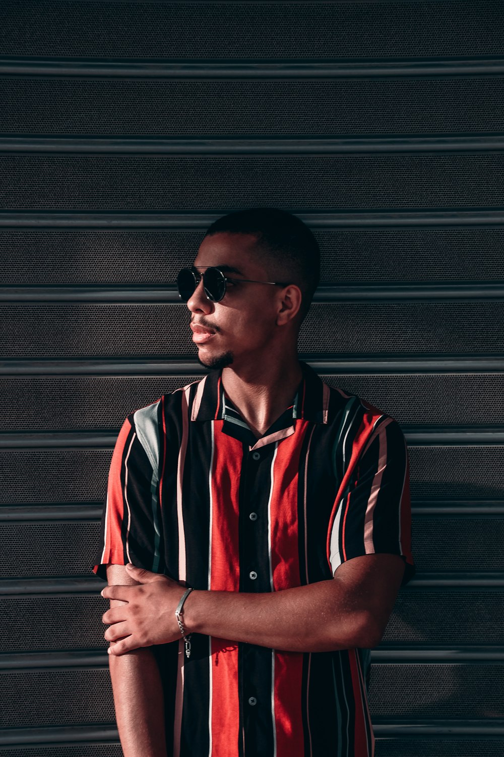 man in black and red polo shirt wearing black sunglasses