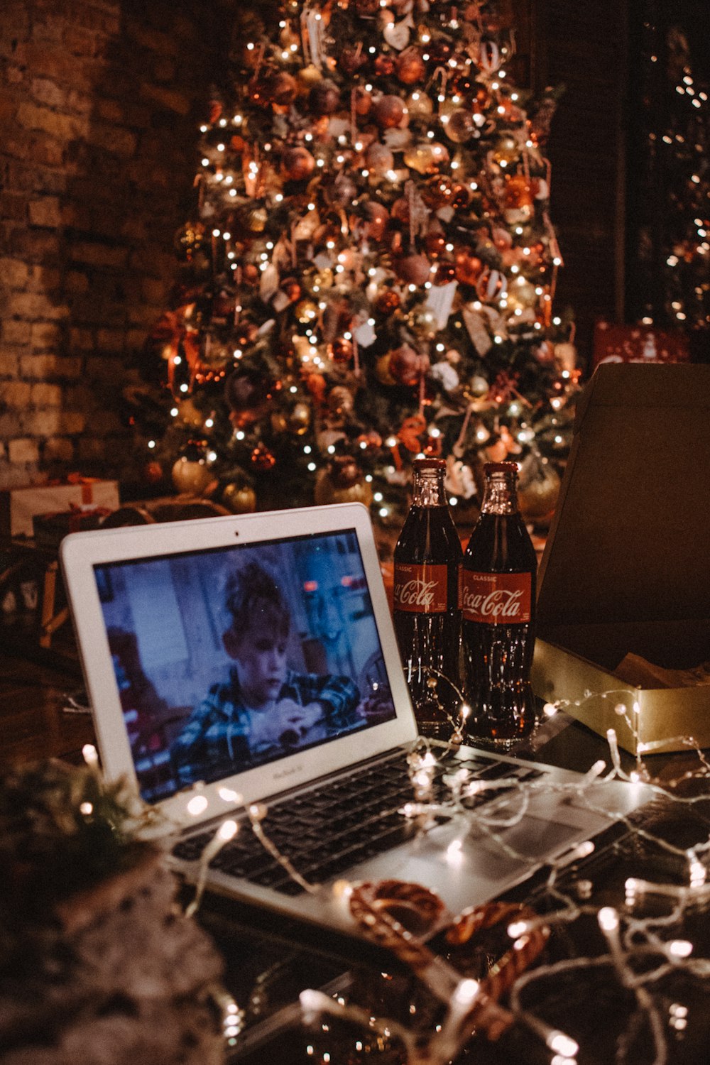 macbook air on table near christmas tree