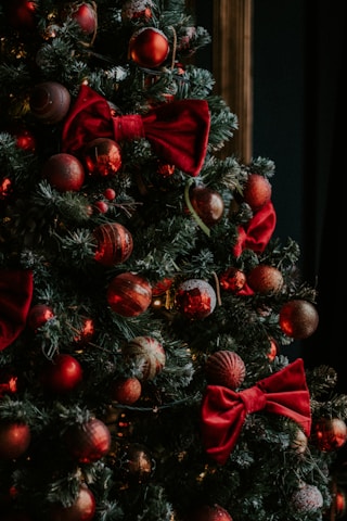 green and red christmas tree with baubles